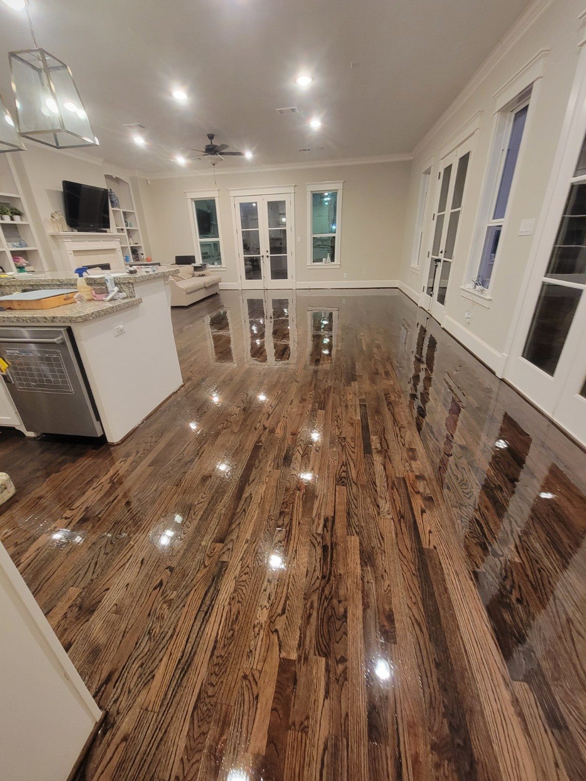 Dark glossy hardwood floor in a living and kitchen area
