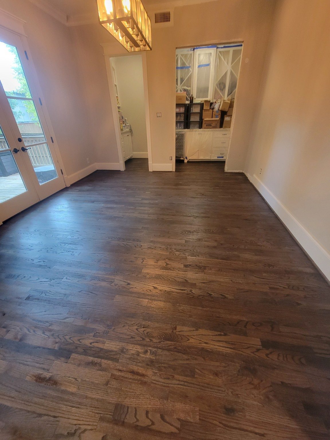 Wood flooring in a room with French doors